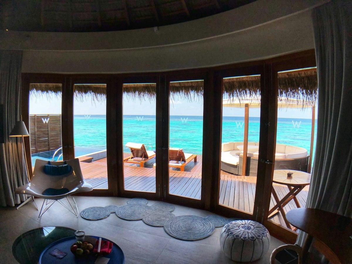 An overwater villa looking out over turquoise sea